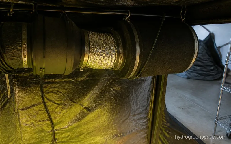 Compact inline fan and carbon filter mounted to grow tent with ducting